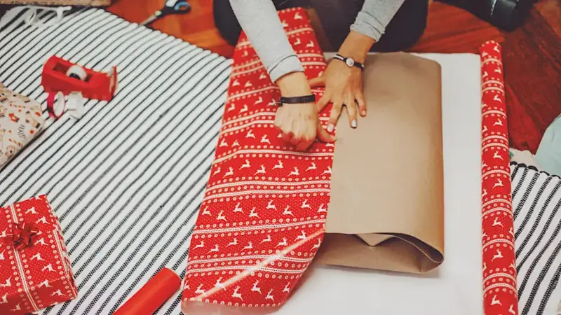 closeup image woman wrapping gifts