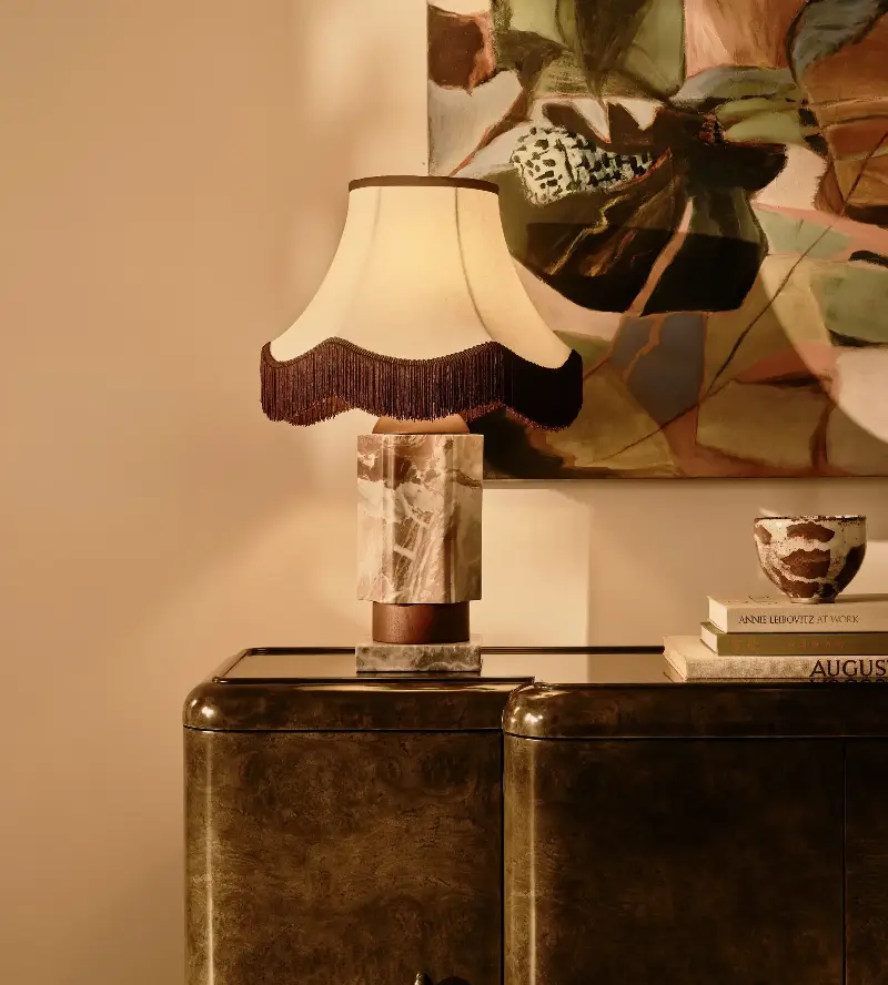 This fringed lampshade — Soho Home's Derwent Table Lamp — adds a soft, layered glow to the space, bringing texture and an elevated feel even when switched off. (Image credit: Soho Home)