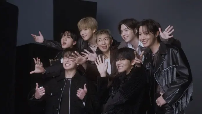 BTS posing together with playful expressions, showcasing a fun and lively atmosphere.
