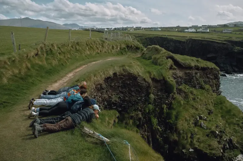Friends peer down from the cliffs to the sea in Dingle, on April 21. MICHAEL VINCE KIM