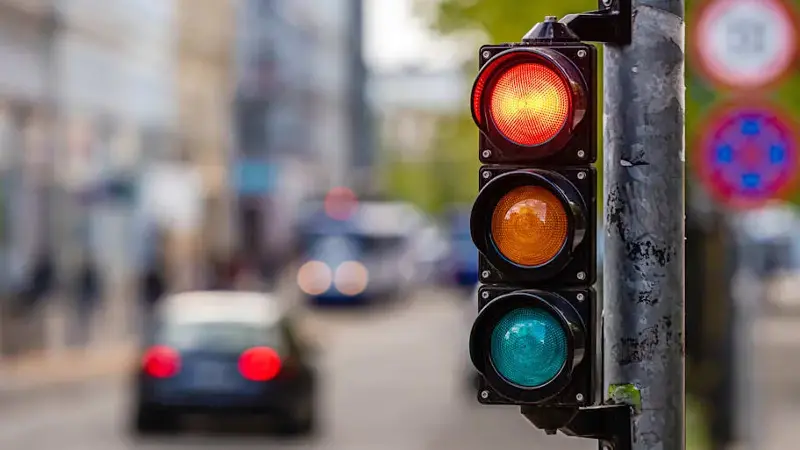 a city crossing with a semaphore, red light in semaphore