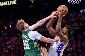 Embiid posts triple-double to keep 76ers perfect