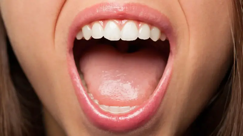 Close-up of a woman opening her mouth to check oral cancer