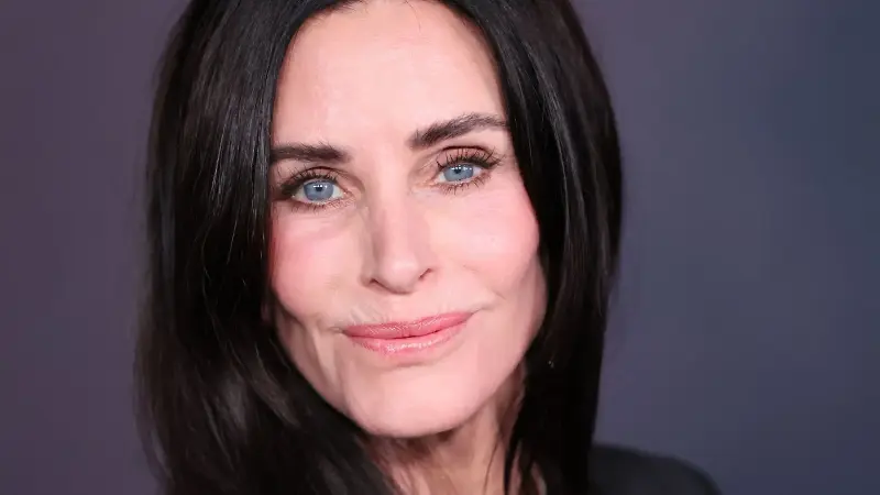 courteney cox on a navy background