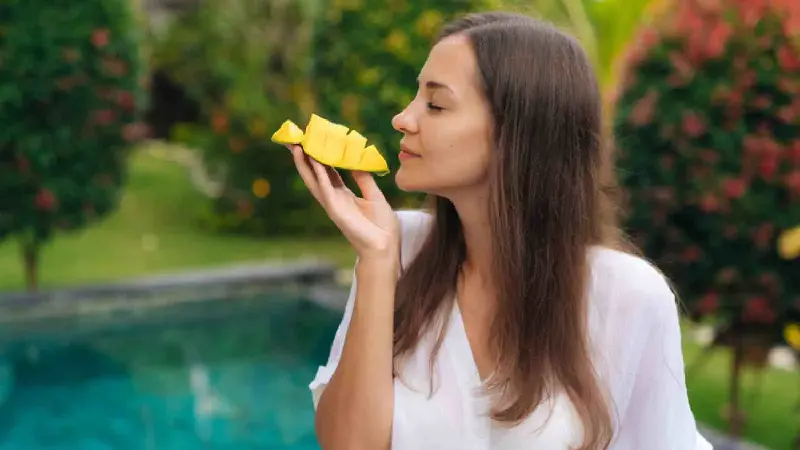 Woman eating mango 