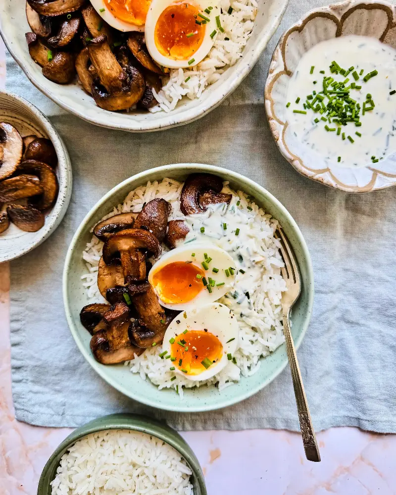 Basmati rice topped with golden mushrooms, jammy eggs and herby yoghurt (The Rice Association)