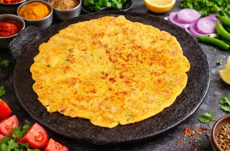 A wholesome savoury Indian pancake made from gram flour, herbs, and spices. Perfect for rainy-day breakfasts or evening snacks. 