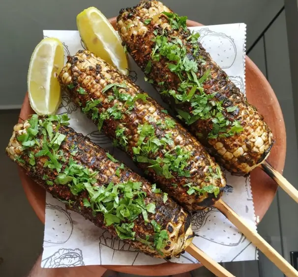 Charred over an open flame and rubbed with lemon, chilli, and salt, roasted corn delivers the perfect balance of sweetness, spice, and nostalgia. 