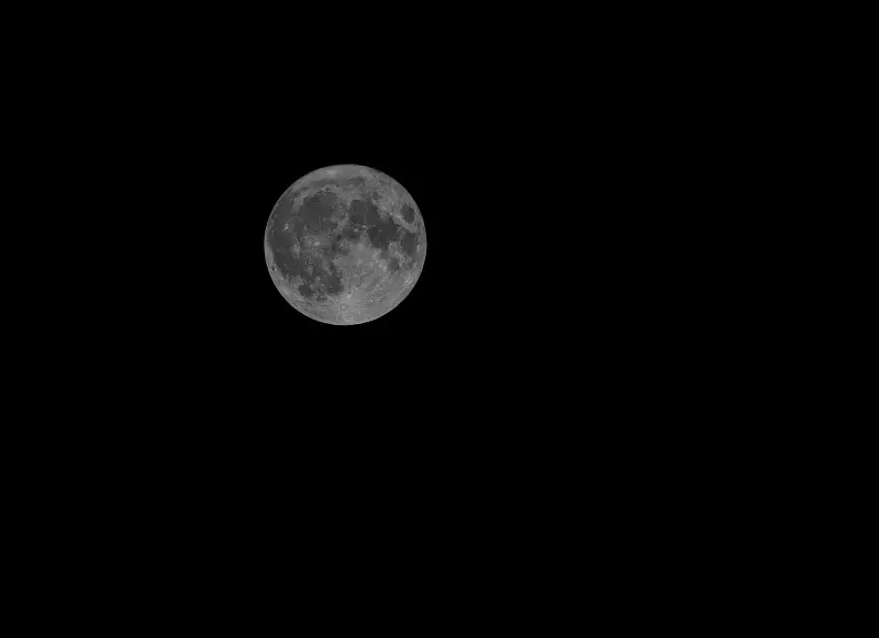 A detailed full Moon against a dark night sky.