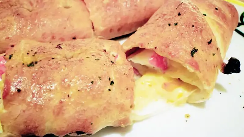 A cut in peices of pizza rolls