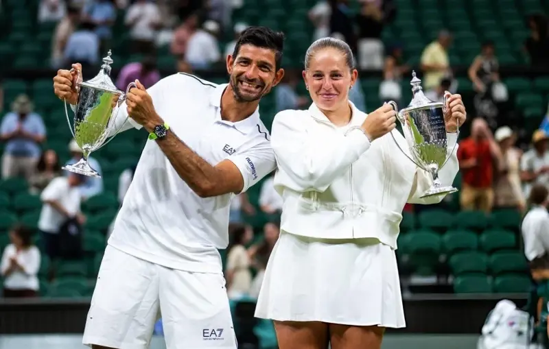 Jelena Ostapenko and Marcelo Arevalo celebrate winning the Wimbledon 2026 mixed doubles title.