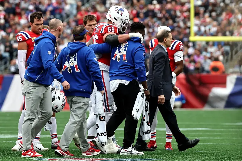 FOXBOROUGH, MASSACHUSETTS - OCTOBER 11: Will Campbell #66 of the New England Patriots is helped off the field against the Las Vegas Raiders during the second quarter at Gillette Stadium on October 11, 2026 in Foxborough, Massachusetts. (Photo by Winslow Townson/Getty Images)