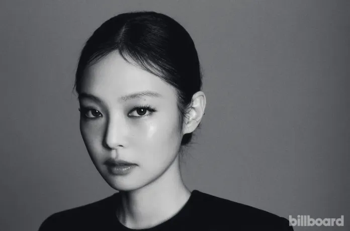 Jennie with sleek hair pulled back, showcasing her striking features and intense gaze.