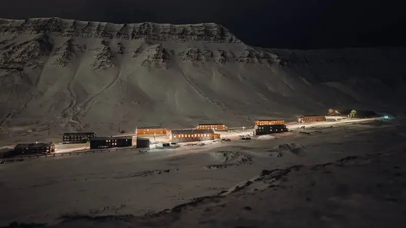 View of Nybyen in Longyearbyen, Svalbard at night from atop mountainside