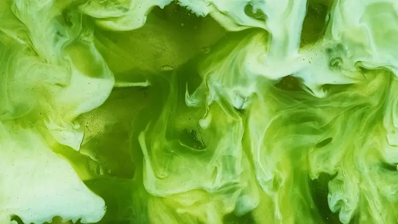 Pour of milk into iced matcha