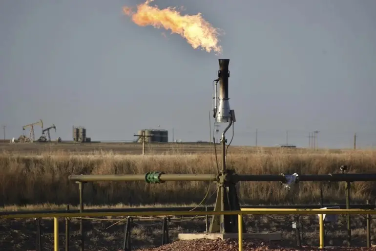 A flare for burning excess methane, or natural gas, from crude oil production, is seen at a well pad east of New Town, N.D., May 18, 2021. The Interior Department on Monday, Nov. 28, 2022, proposed rules to limit methane leaks from oil and gas drilling on public lands, the latest action by the Biden administration to crack down on emissions of methane, a potent greenhouse gas that contributes significantly to global warming. (AP Photo/Matthew Brown, File)