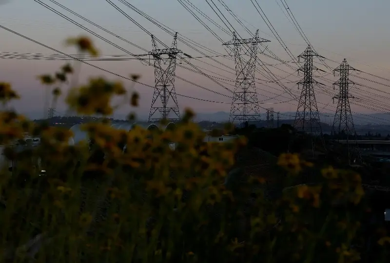 SYLMAR, CALIFORNIA - MARCH 24: A view of electrical transmission towers on March 24, 2026 in Sylmar, California. Rapid growth in AI-driven data centers, combined with the aging U.S. power grid, is creating large, unpredictable electricity demands that could strain the system and increase the risk of cascading outages if not better managed or upgraded. (Photo by Justin Sullivan/Getty Images)