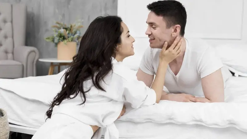 A couple talking in bed
