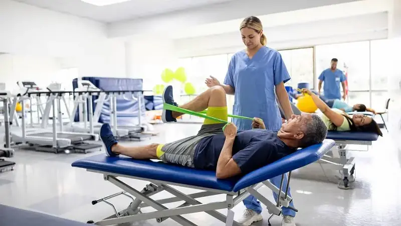 Man doing physical therapy exercises using a stretch band