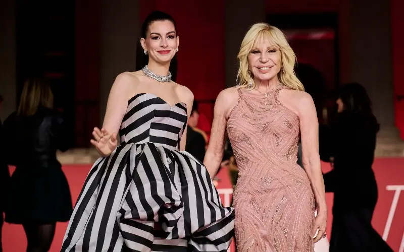 Anne Hathaway and Versace at a photocall for The Devil Wears Prada 2 in London, April 2026 - Getty/Gareth Cattermole