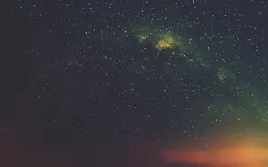 Webb has confirmed a galaxy, MoM-z14, whose light left just 280 million years after the Big Bang, after travelling about 13.5 billion years. The shock was not that one galaxy shone 100 times brighter than expected, but that JWST is finding bright galaxies from this era far more often than pre-Webb models predicted, and MoM-z14 even shows unusual nitrogen enrichment, hinting that star formation and chemical evolution were already moving faster than astronomers expected.