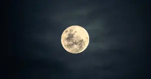 The leading explanation for how the Moon was born is that a world the size of Mars called Theia slammed into the young Earth and flung out the debris that became the Moon, and recent research suggests Theia itself never fully left, with two continent-sized blobs buried near our planet’s core possibly being the last remains of the world that struck us.