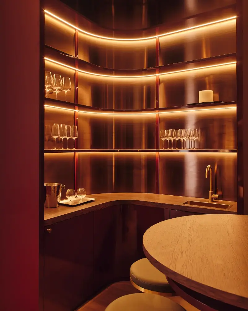 The basement area comes complete with a bar as well as a cinema. Rosie has added high-gloss burgundy lacquer to the joinery to create a highly contemporary space.Studio Hahn. Design: Gangar
