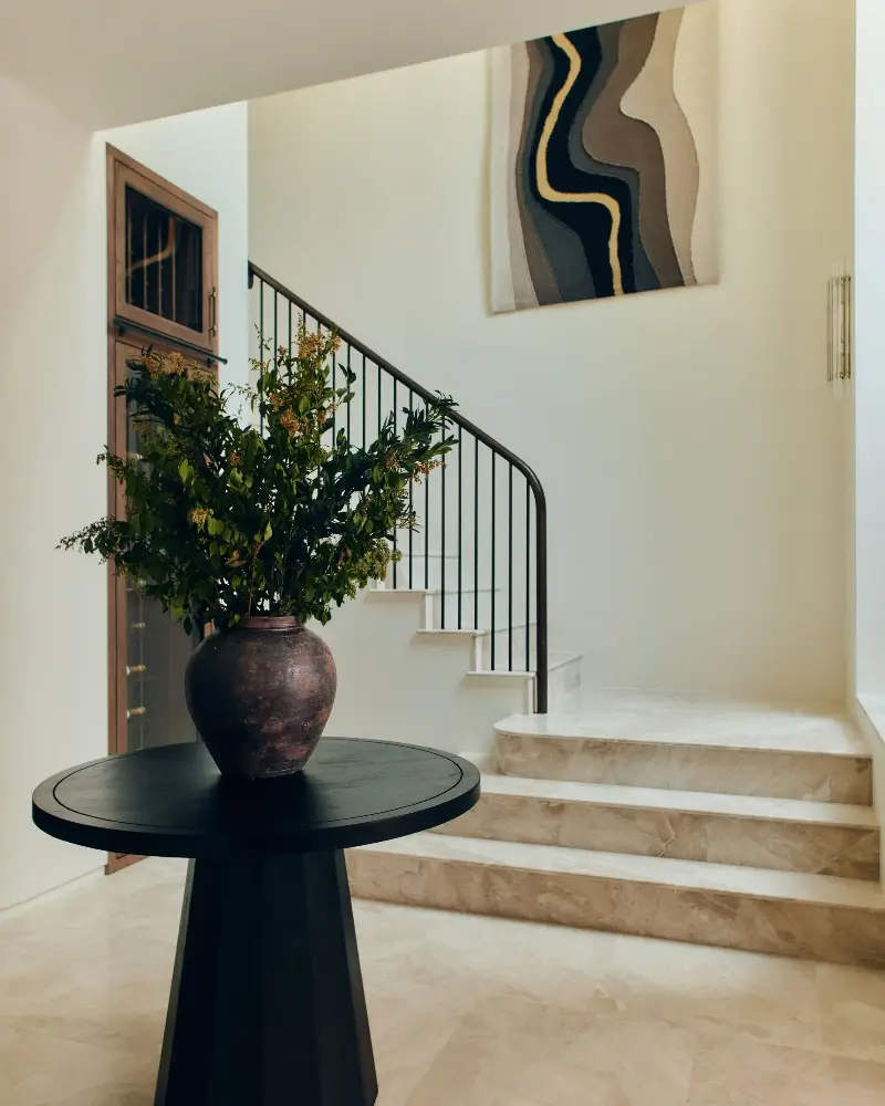 The basement is bright with light pouring through the void, highlighting a homage to London; a tapestry by Nest, Liquid History features the Thames in hand-stitched textiles. (Image credit: Studio Hahn. Design: Gangar)