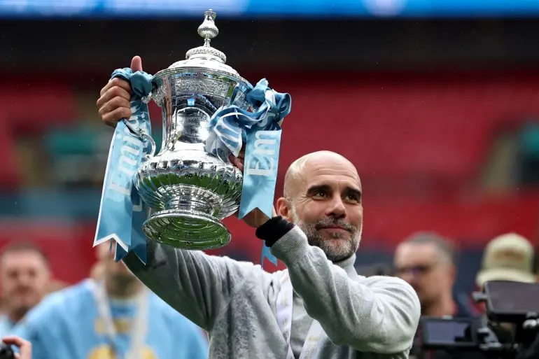 epa12964649 Manchester City's manager Pep Guardiola celebrates with the cup after winning the English FA Cup final match Chelsea FC against Manchester City, in London, Britain, 16 May 2026. EPA/NEIL HALL EDITORIAL USE ONLY. No use with unauthorized audio, video, data, fixture lists, club/league logos, 'live' services or NFTs. Online in-match use limited to 120 images, no video emulation. No use in betting, games or single club/league/player publications.