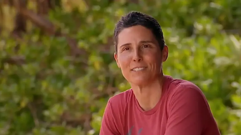 Jeff Probst wears an orange hat and blue shirt while talking on Survivor.