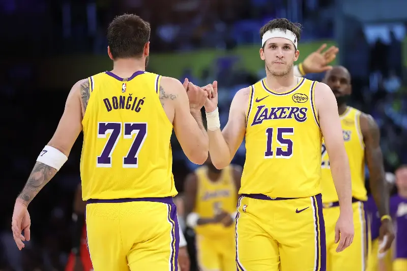 LOS ANGELES, CALIFORNIA - MARCH 12: Luka Doncic #77 and Austin Reaves #15 of the Los Angeles Lakers hold hands during a time out in the second half of a game against the Chicago Bulls at Crypto.com Arena on March 12, 2026 in Los Angeles, California. (Photo by Sean M. Haffey/Getty Images)