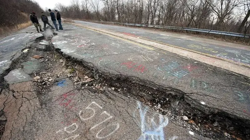 A group explores a large crack in PA Highway 61, caused by the underground coal fire in Centralia.