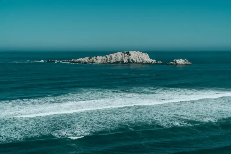 Breathtaking oceanic view with rocky island near Matanzas, O'Higgins, Chile.