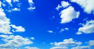 The blue color of the sky is not a property of the air itself — air is colorless, and a glass of it would look exactly like a glass of nothing — and the blue you see overhead is sunlight being scattered by molecules of nitrogen and oxygen, which deflect short blue wavelengths much more strongly than long red ones, in the same physics that makes the Sun appear yellow and a sunset appear red