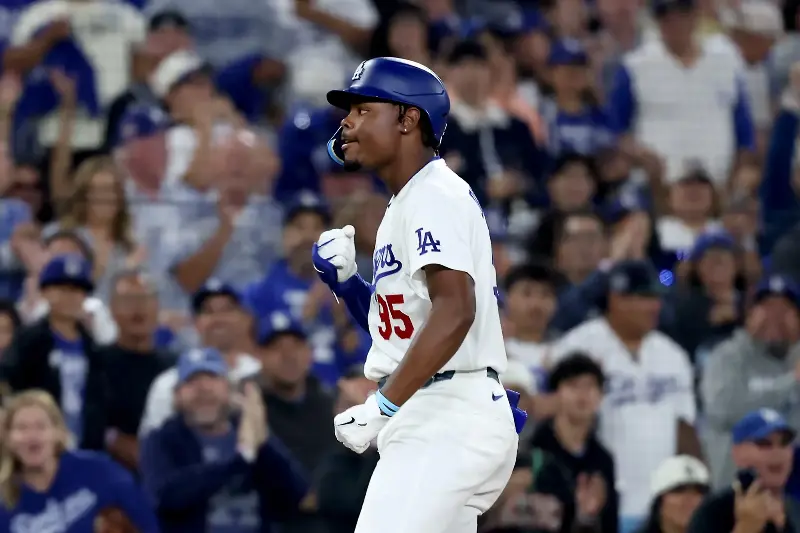 LOS ANGELES, CALIFORNIA - SEPTEMBER 22: Josue De Paula #95 of the Los Angeles Dodgers reacts after hitting a triple during the sixth inning against the San Diego Padres at Dodger Stadium on September 22, 2026 in Los Angeles, California. (Photo by Katelyn Mulcahy/Getty Images)