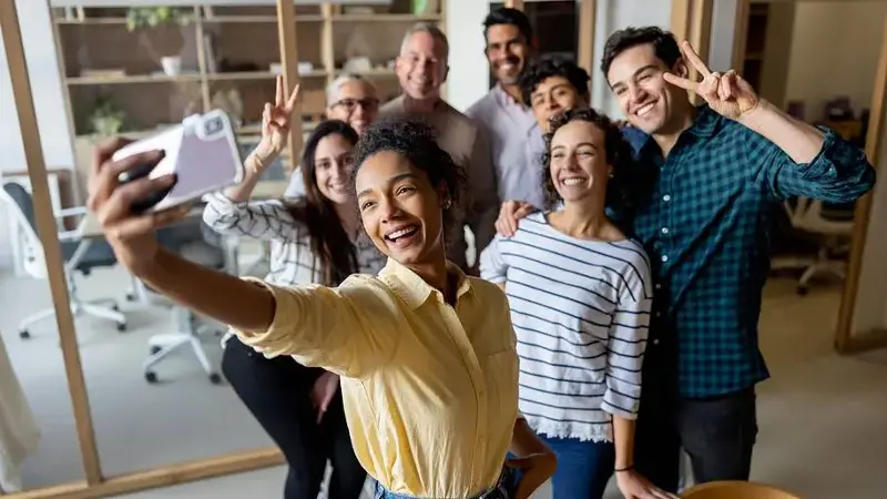 Happy business team taking a selfie at the office