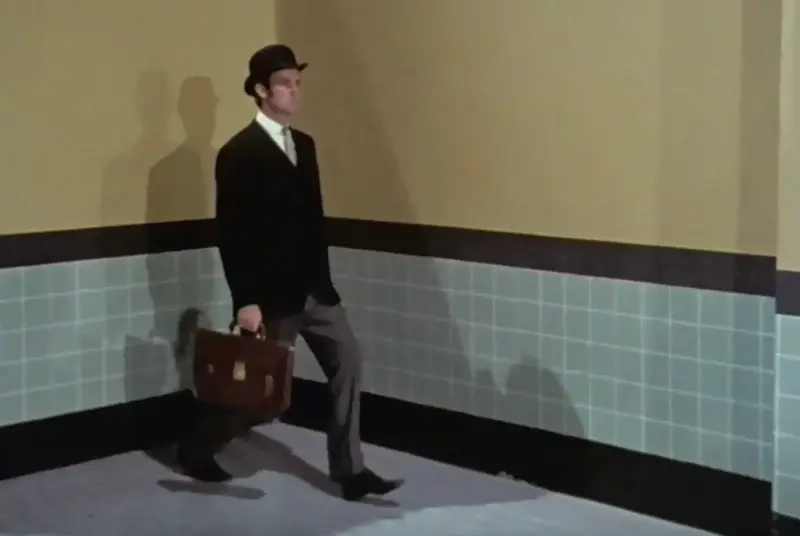 Actor John Cleese performs a silly walk in the legendary Monty Python sketch, Ministry of Silly Walks in 1970 (Public Domain)