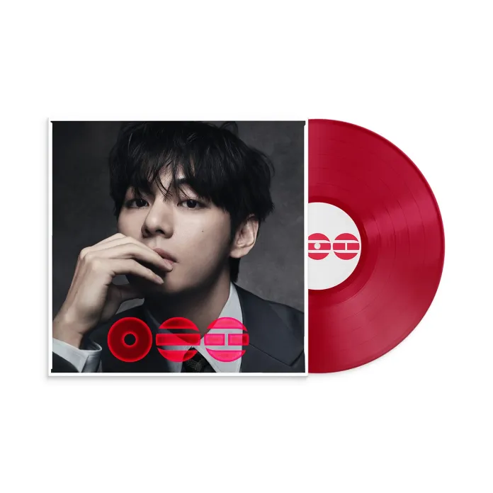 A red vinyl record next to an album cover featuring a close-up of a V with dark hair, wearing a suit, resting his chin on his hand.