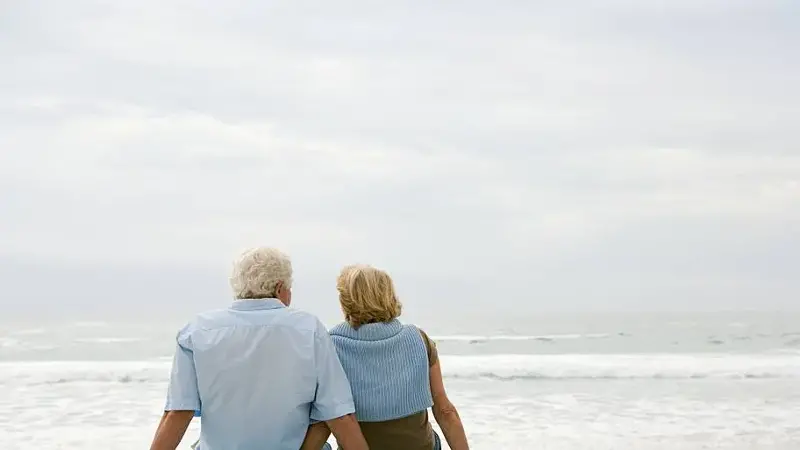 Senior couple sitting on a beach