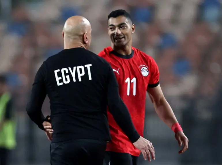 Soccer Football - International Friendly - Egypt v Nigeria - Cairo International Stadium, Cairo, Egypt - December 16, 2025 Egypt's Mostafa Mohamed reacts with coach Hossam Hassan as he is substituted REUTERS/Amr Abdallah Dalsh