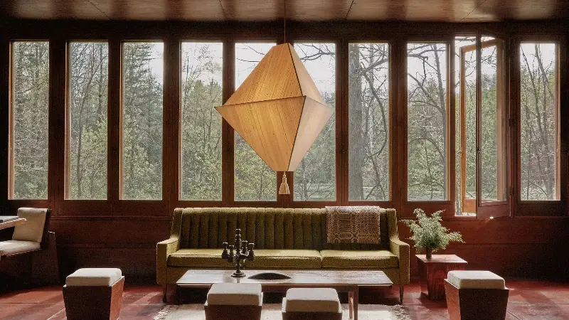 Large pyramid lantern with single tassel in wood-walled mid-century living room