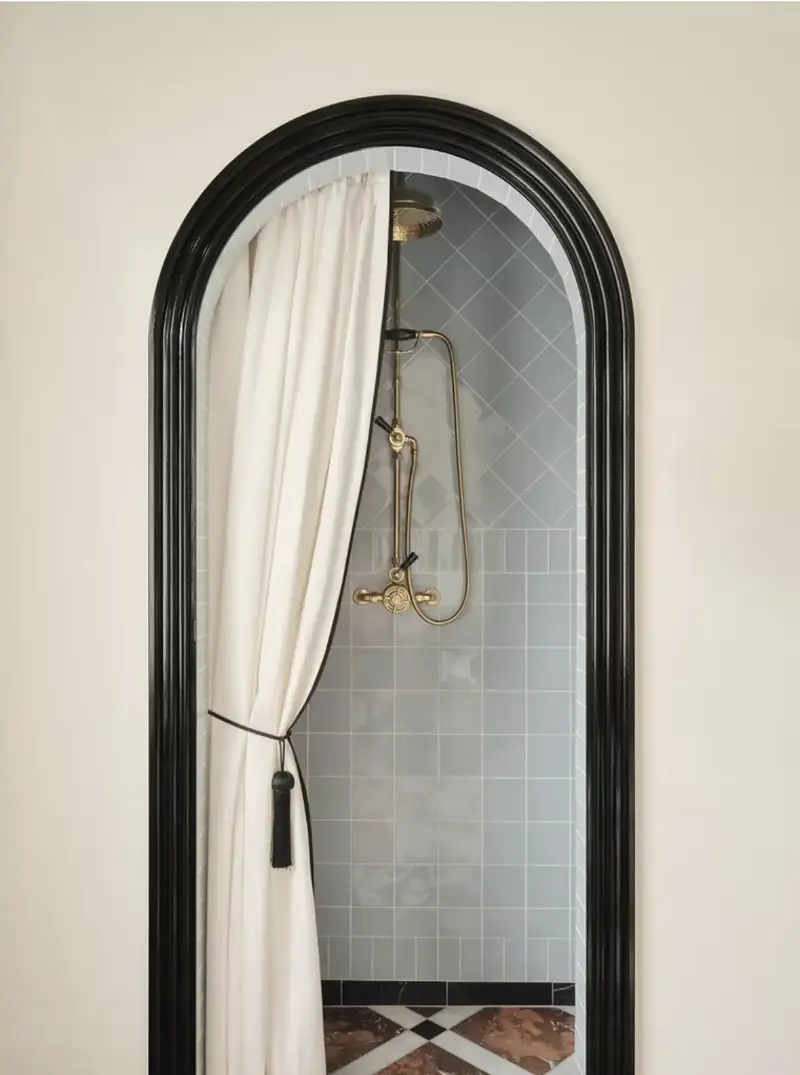 Penrose Tilbury adorned this shower curtain with a black tassel tieback, a small detail that's both elegant and surprisingly impactful. (Image credit: Penrose Tillbury)