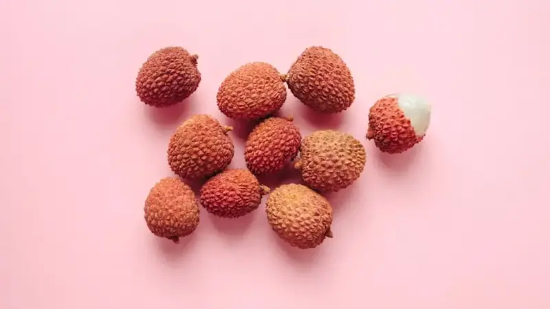 Lichee (lychee) fruits over pink background