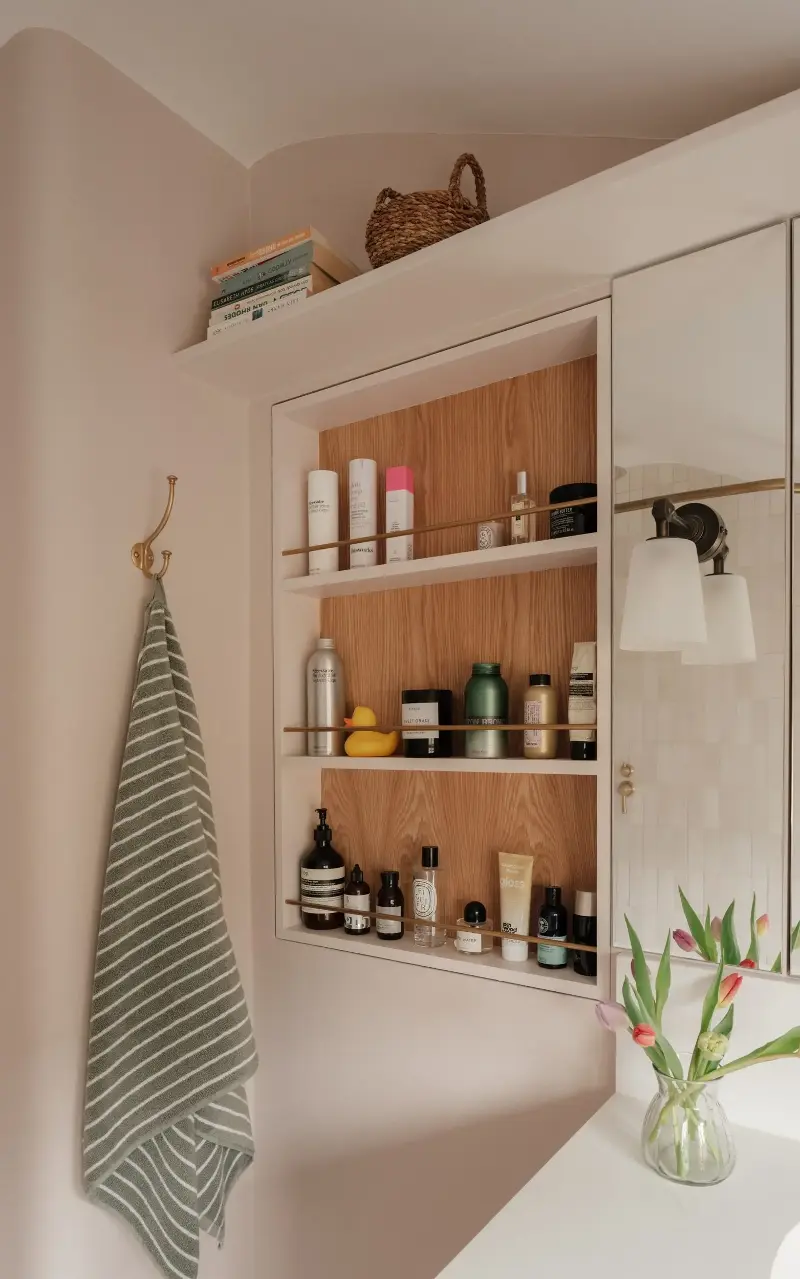 Recessed shelves with a rail along the front to hold things in is both practical for easy access and can be dressed up or down with vintage or contemporary materials