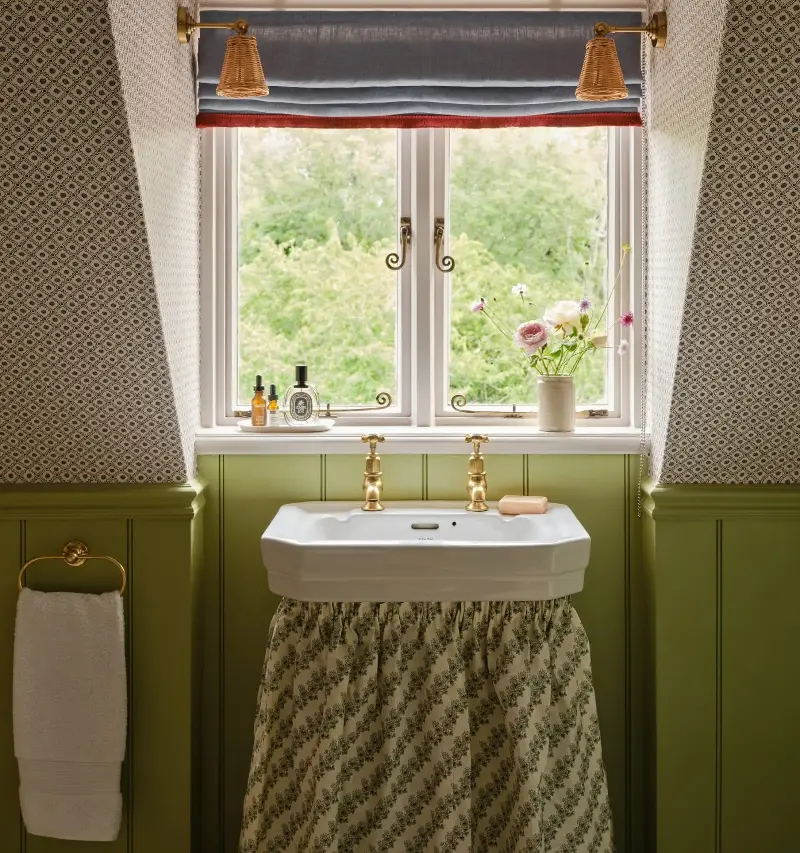 A sink skirt can conceal unsightly piping and creates a hidden spot for loo roll or cleaning products