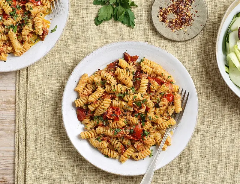 Baked feta and cherry tomatoes make an easy, creamy sauce for fusilli (Abel & Cole)