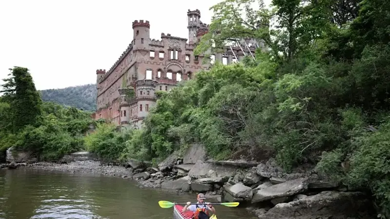 A kayaker rows by the abandoned Bannerman Castle in New York