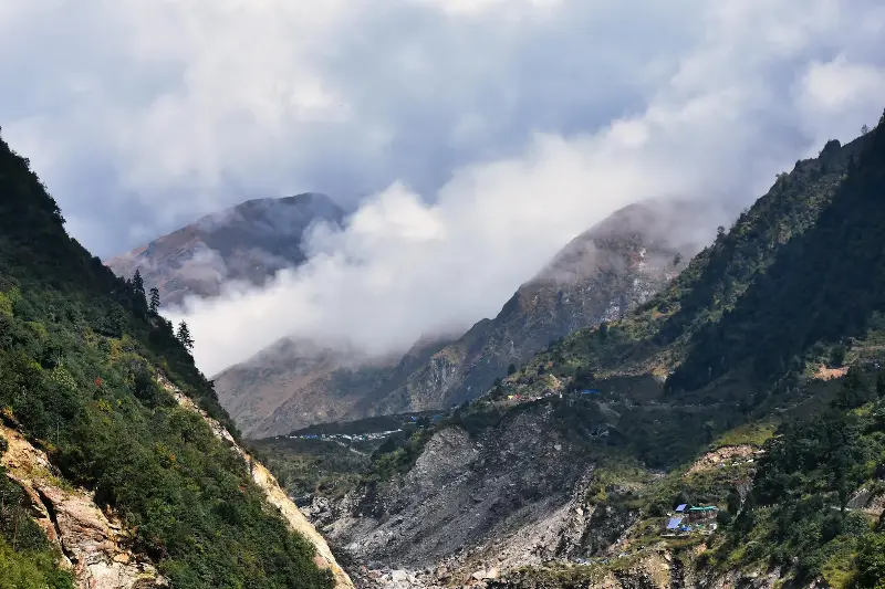 Stunning aerial view of Kedarnath Valley with majestic mountains and swirling clouds.
