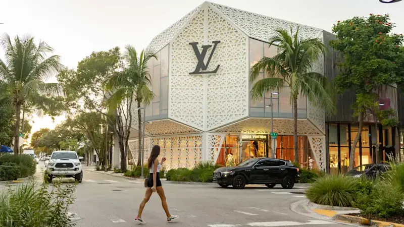 Woman Crossing the Street by Louis Vuitton Store in Miami Design District