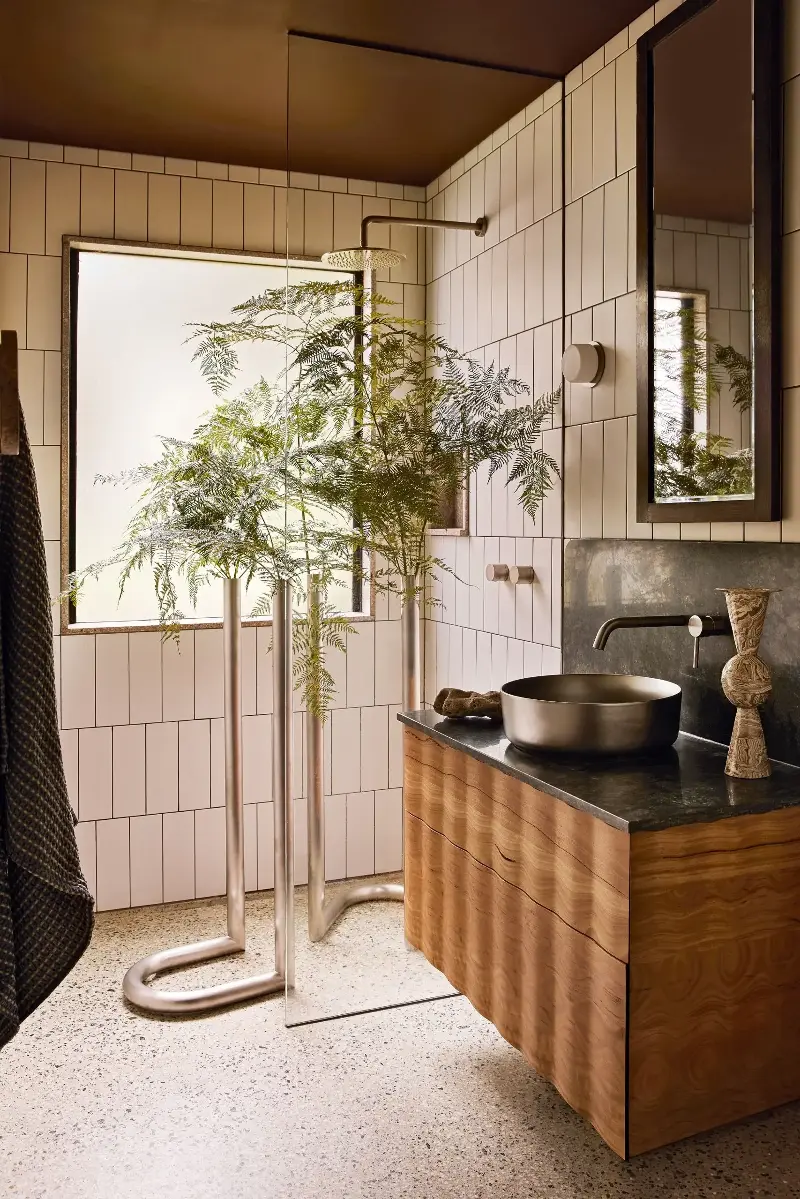 The bespoke wavy timber vanity in the bathroom is the kind of detail that makes this home so interesting. 